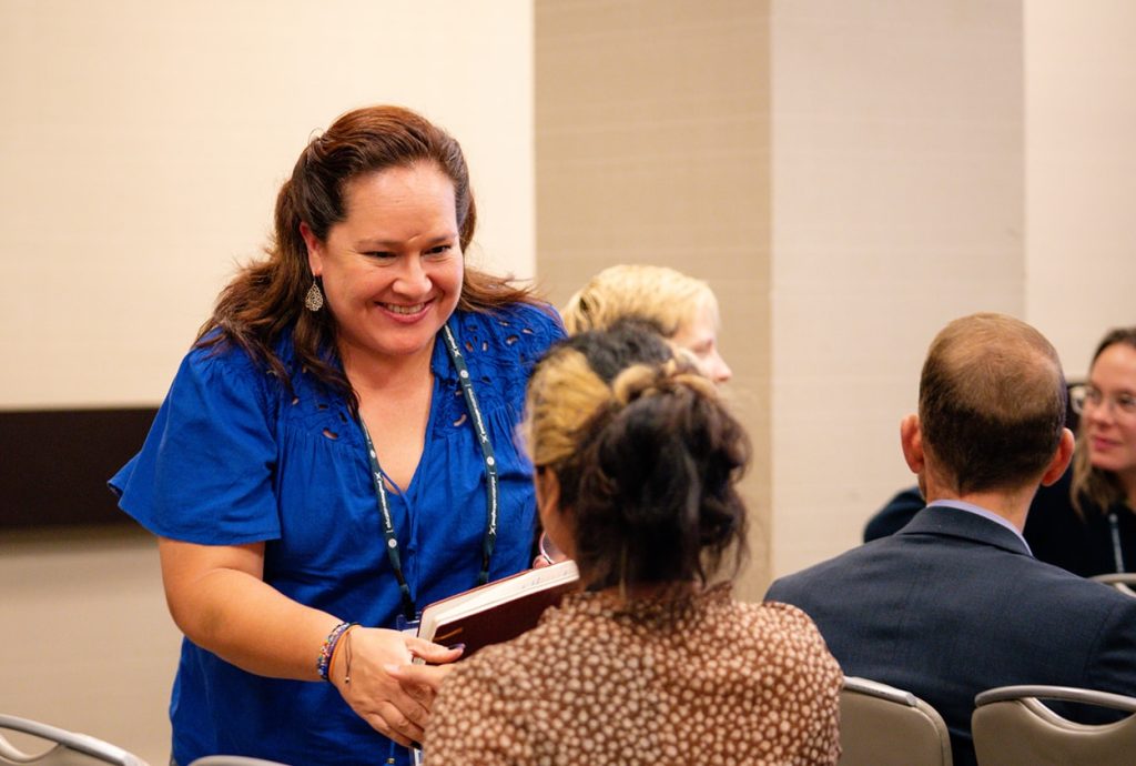 conference attendee smiling while engaging in session